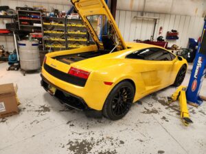 A yellow lamborghini is parked in the garage.
