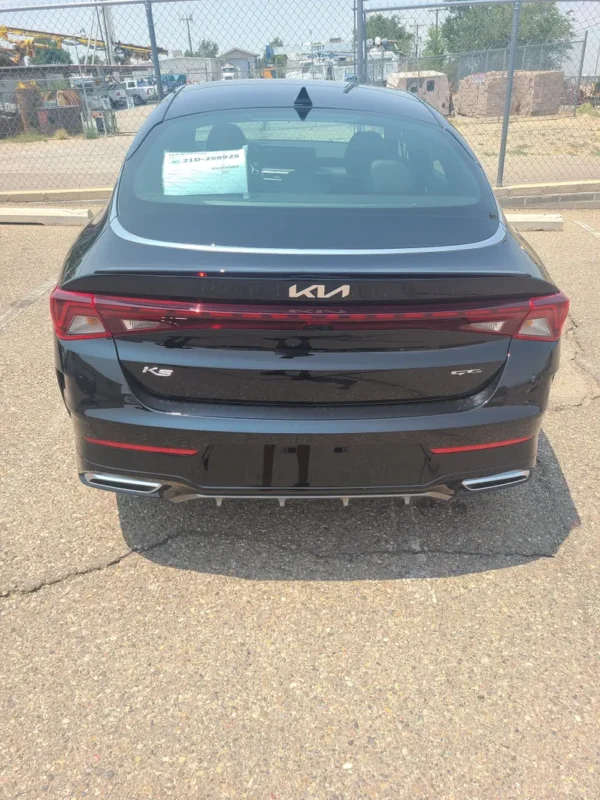 A black car parked in the parking lot