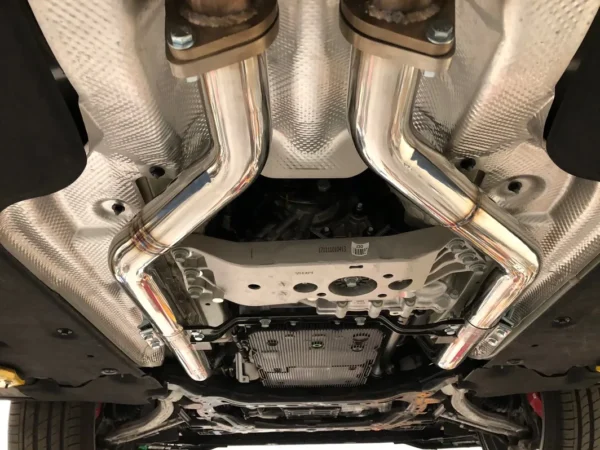 A car with two exhaust pipes on the back of it.
