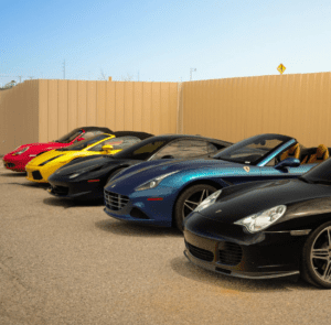 A row of colorful sports cars parked in a parking lot.